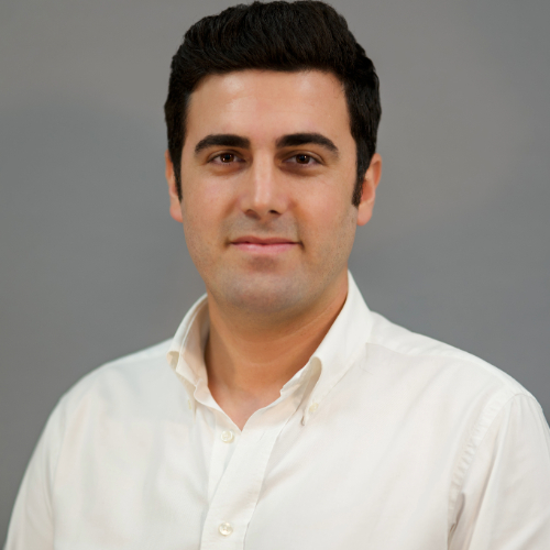 Professional portrait of a man in a white shirt.