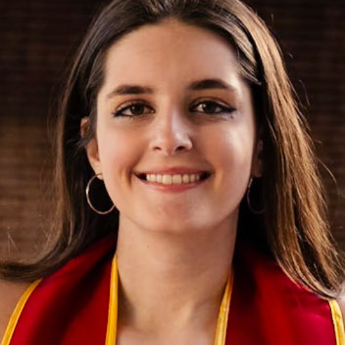A young woman smiles, wearing a red and yellow stole.