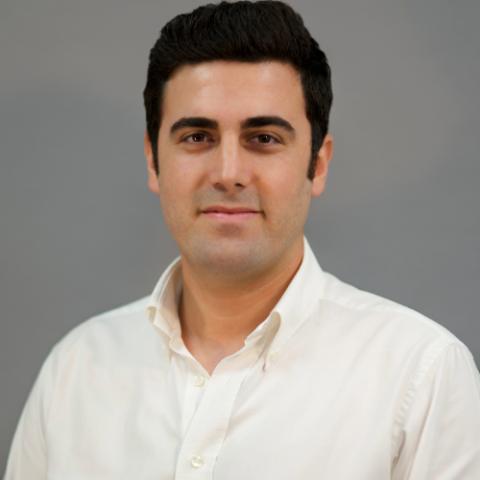 Professional portrait of a man in a white shirt.