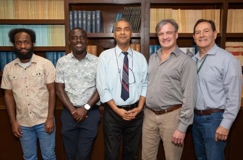The SMART-pred team posing and smiling in front of a bookshelf